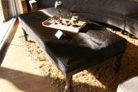 Cowhide Ottoman in Chocolate with Wood Carved Legs